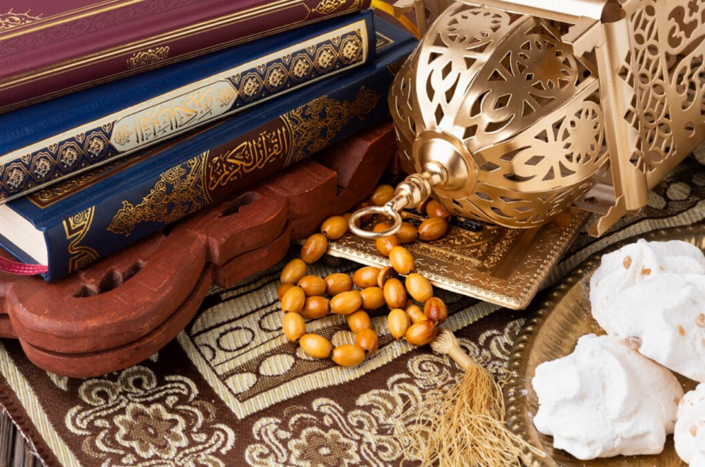 Islamic books including the Holy Quran, a decorative Ramadan lantern, wooden prayer beads (tasbih), and traditional Islamic décor.